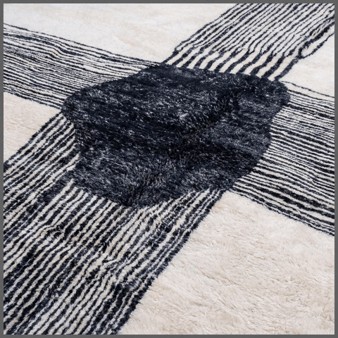 Close-up detail of a textured pattern on a black and white Moroccan rug.
