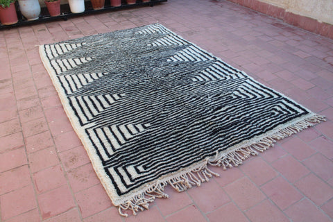 Detail close-up of the black and white rug showcasing its geometric pattern and texture.