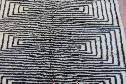 Close-up detail of the black and white rug highlighting its geometric pattern and soft texture.