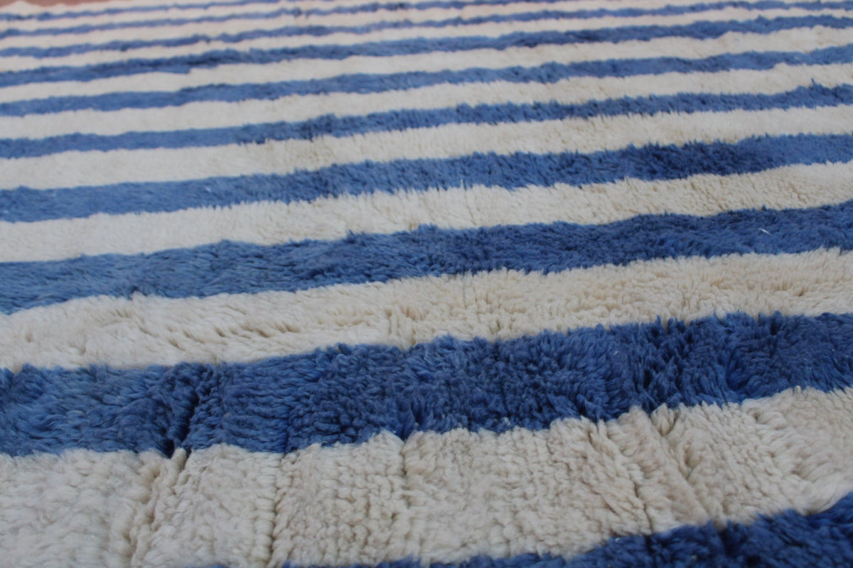Front view of a blue striped Moroccan rug with horizontal stripes.