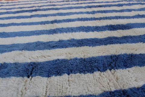Front view of a blue striped Moroccan rug with horizontal stripes.