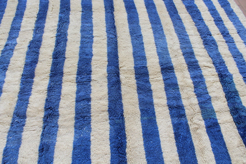 Close-up of a blue striped rug focusing on the striped pattern.