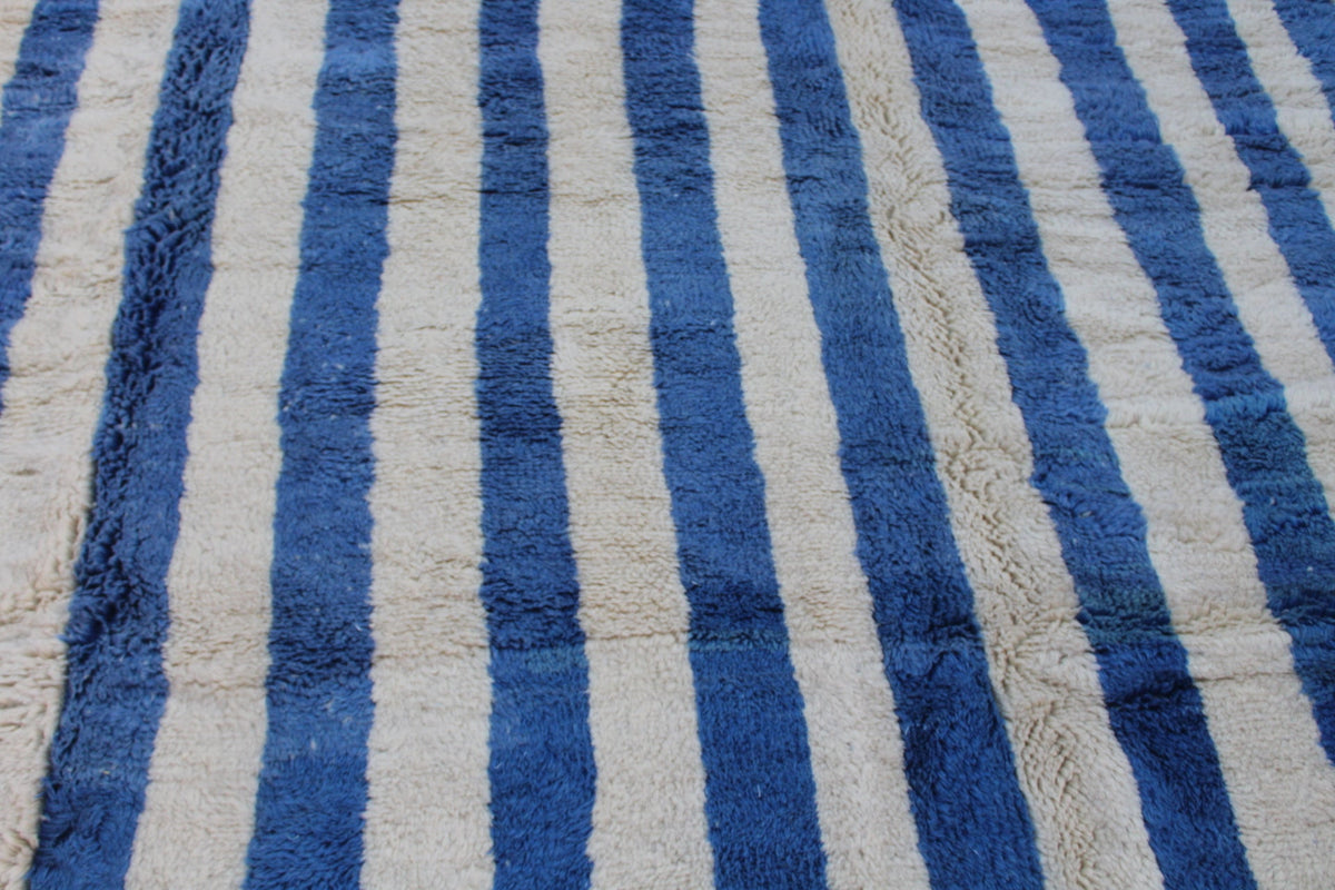 Detail view of a blue striped rug showcasing its woven texture.