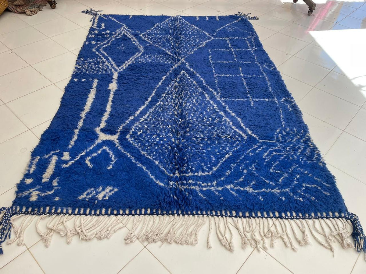 Close-up detail of the blue vintage Moroccan rug showcasing intricate patterns on a solid background.