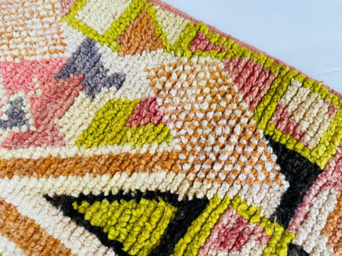 Detail shot of the abstract Moroccan rug showcasing colorful geometric patterns.