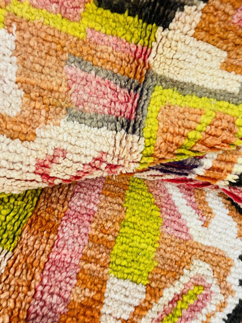 Lifestyle view of the orange abstract Moroccan rug showcasing its colorful patterns.