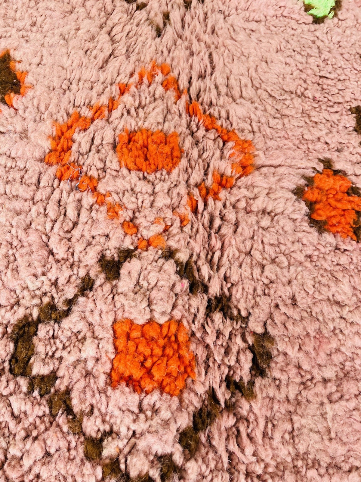 Detail shot of the orange geometric Boujaad Moroccan rug displaying abstract patterns and vibrant colors.