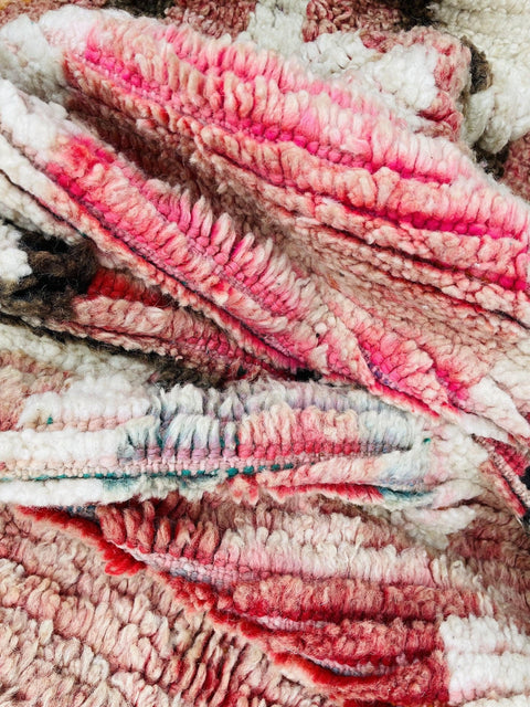 Close-up detail of the woven texture with soft fibers in red and white.