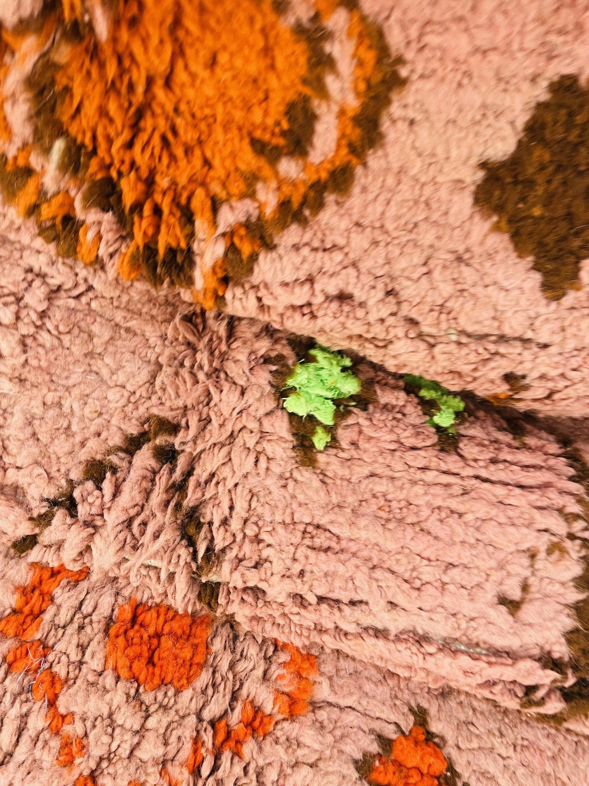 Lifestyle image showcasing the orange geometric Boujaad Moroccan rug with bohemian style and abstract patterns.