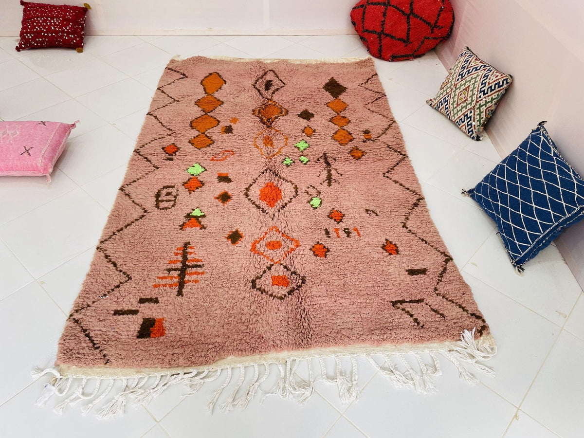 Lifestyle view of the orange geometric Boujaad Moroccan rug featuring abstract designs and colorful accents.
