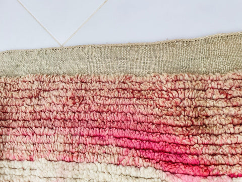 Detail shot of the woven texture in red, white, and beige on a white background.