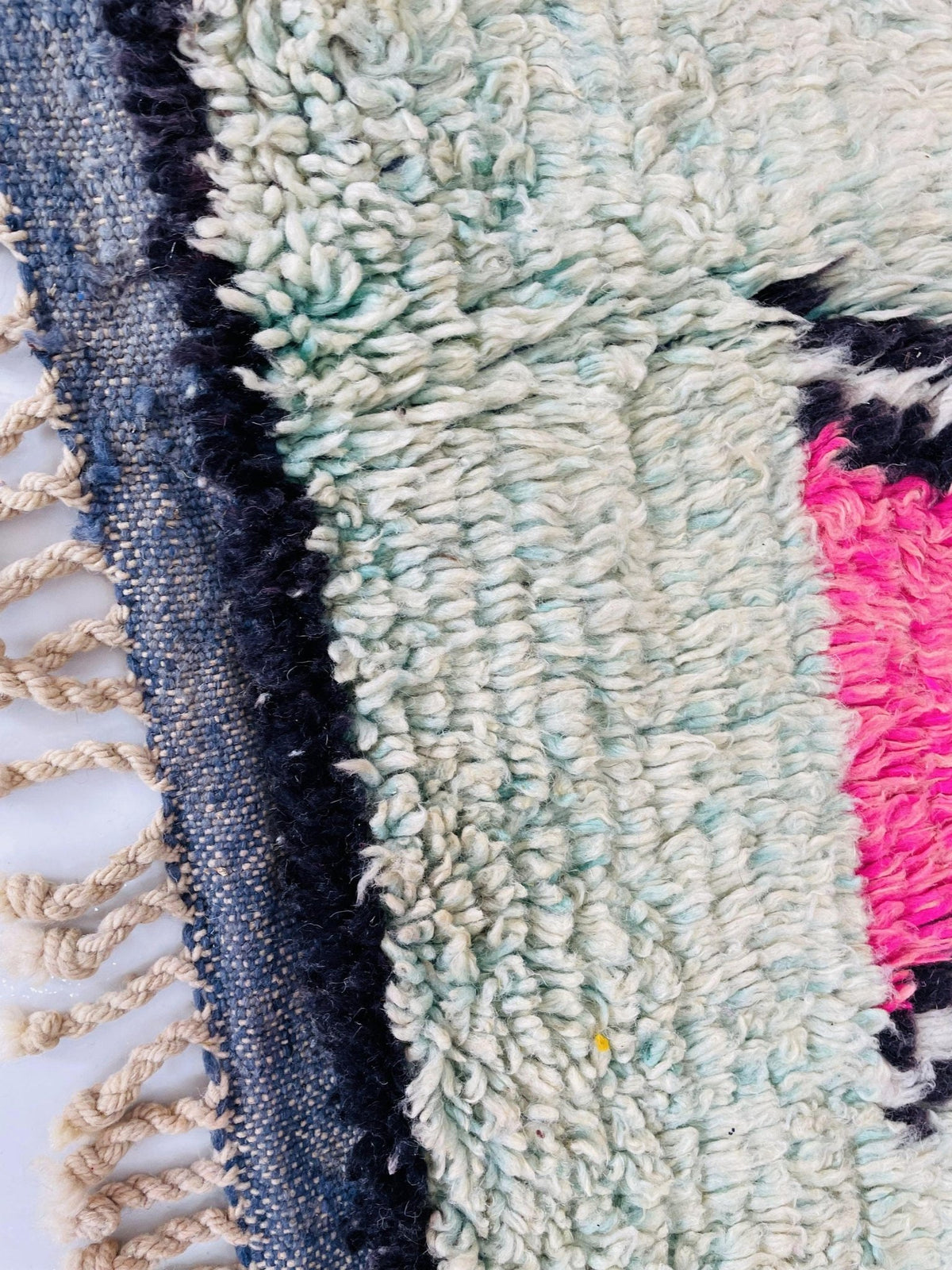 Close-up of the textured fibers and colorful design of the Boujaad Moroccan rug.