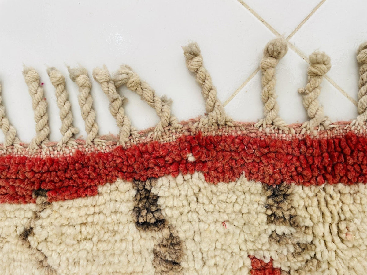 Detail shot of an abstract Moroccan rug showcasing purple and red colors.