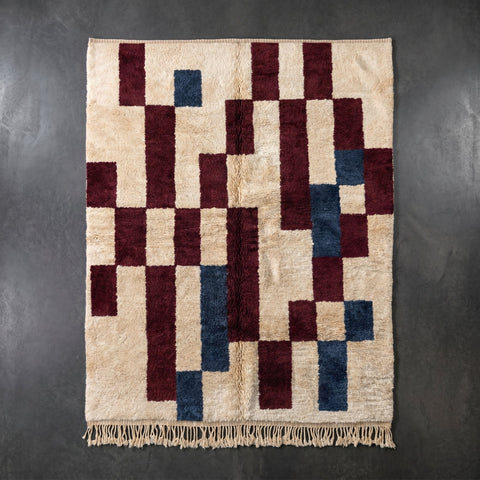 Front view of a burgundy Moroccan rug showcasing geometric designs and fringe edges.