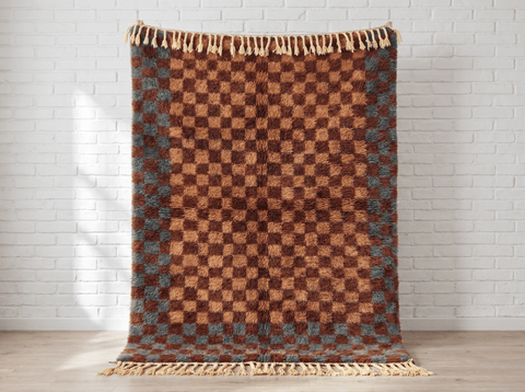Front view of a burgundy checkered Moroccan rug with geometric patterns on a white background.
