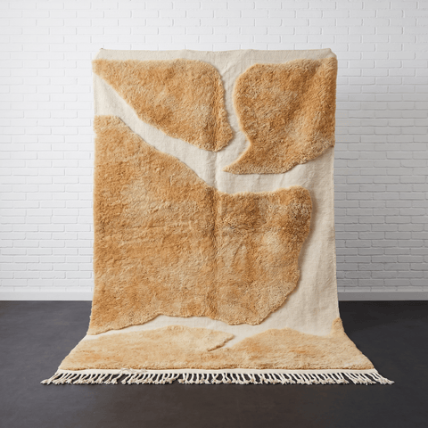 Front view of the camel brown Moroccan rug featuring fringe edges against a solid background.