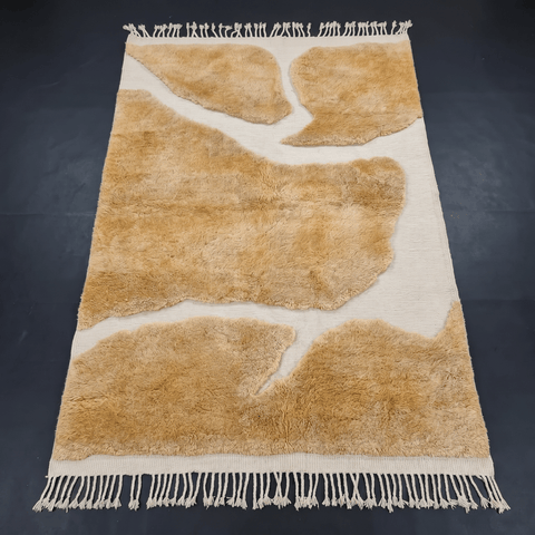 Front view of the camel brown Moroccan rug showcasing its design and fringe edges on a solid background.