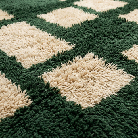 Close-up detail of the rug edge highlighting fringe detail and textured surface.