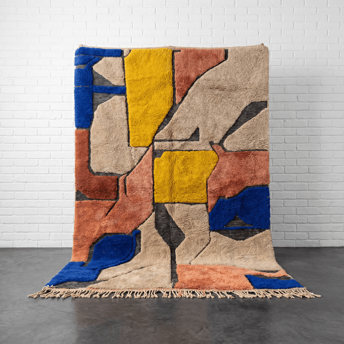 Front view of a colorful Moroccan rug featuring an abstract pattern with fringe edges.