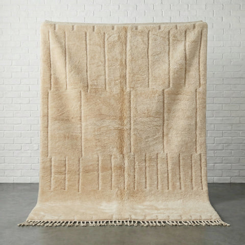 Lifestyle view of a cream tufted rug in a natural setting, showcasing modern design.