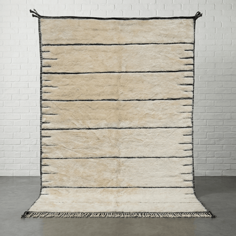 Front view of a cream tufted Moroccan rug with a striped pattern on a studio background.