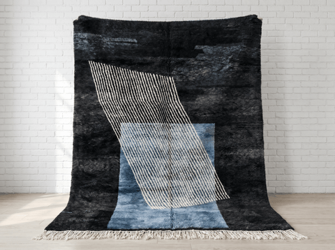 Detail of the deep charcoal Moroccan rug showcasing geometric patterns and soft texture.
