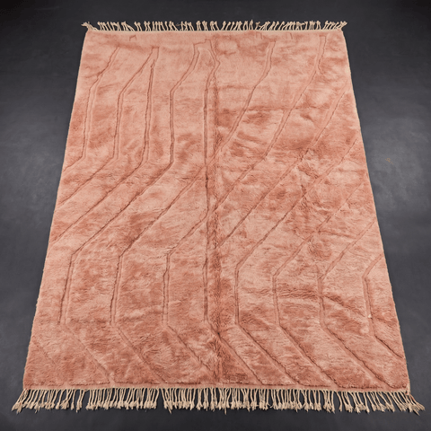 Close-up detail of the dusty rose pink Moroccan rug showcasing its design and colors.