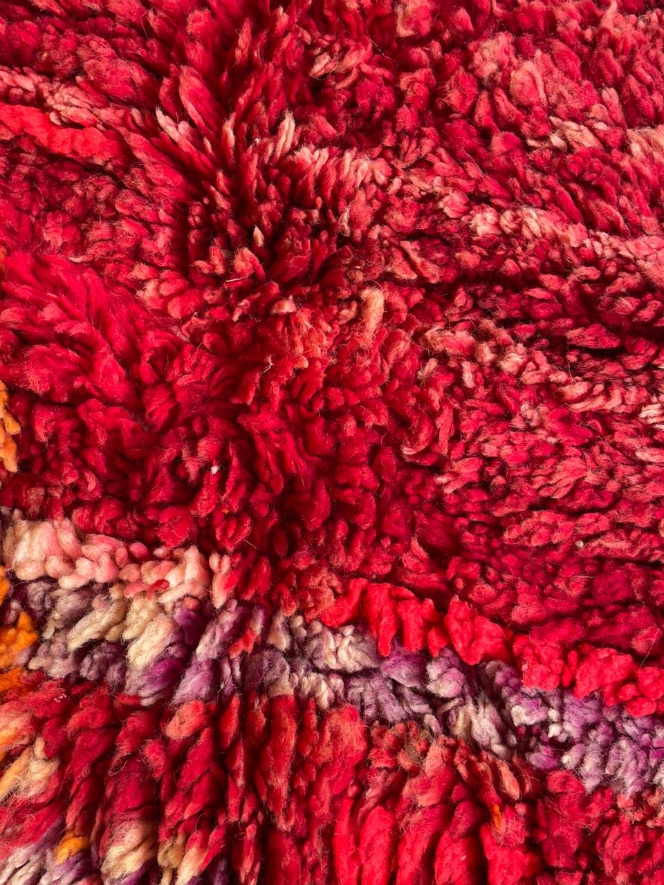 Detail shot of the rich texture and colorful patterns on a vintage Moroccan rug.