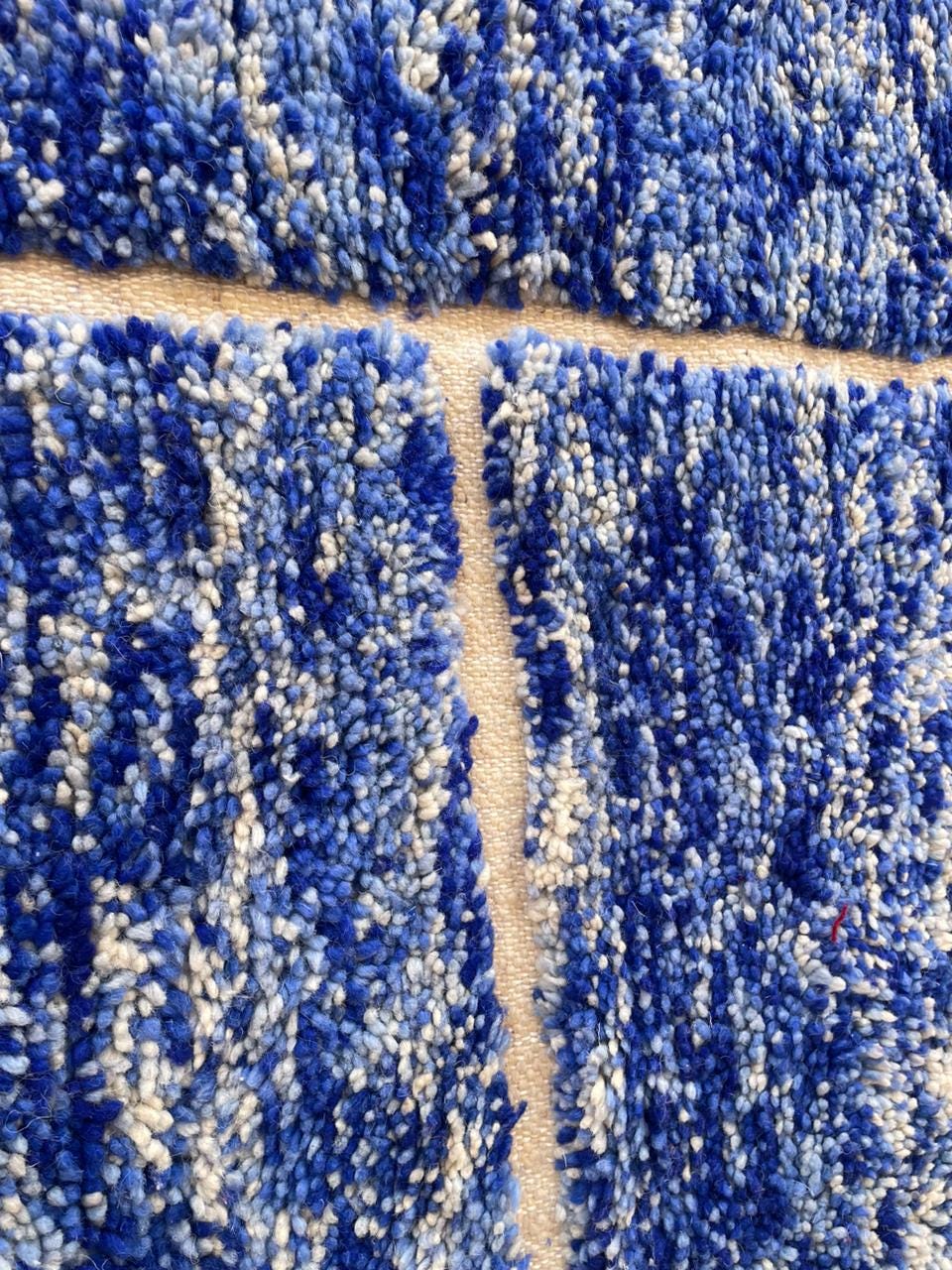 Detail shot highlighting the close-up pattern of a blue Moroccan rug.
