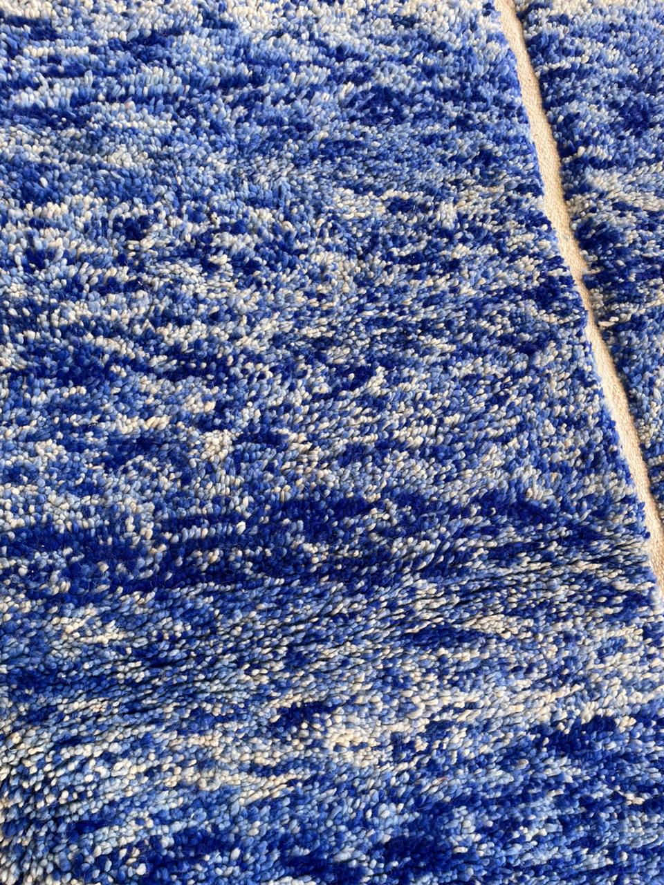 Close-up detail of a blue Moroccan rug showcasing its textured pattern.