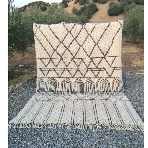 Front view of a cream checkered Moroccan rug showcasing black geometric patterns and fringe edges.