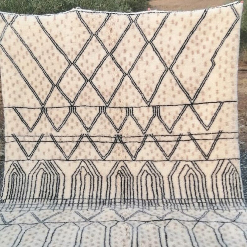 Front view of a cream checkered Moroccan rug with beige and black geometric patterns and fringe edges.