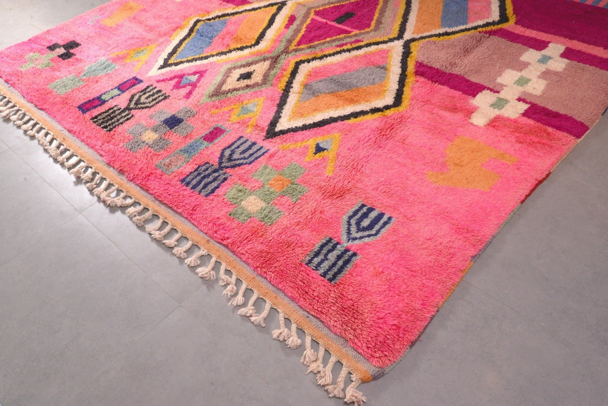 Detail close-up of a pink Moroccan rug highlighting its geometric patterns.