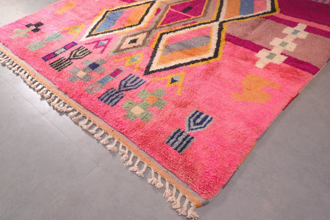 Detail close-up of a pink Moroccan rug highlighting its geometric patterns.