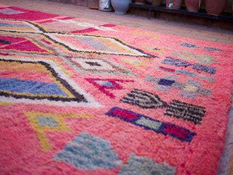 Close-up of a pink Moroccan rug showcasing varied patterns and soft shag.