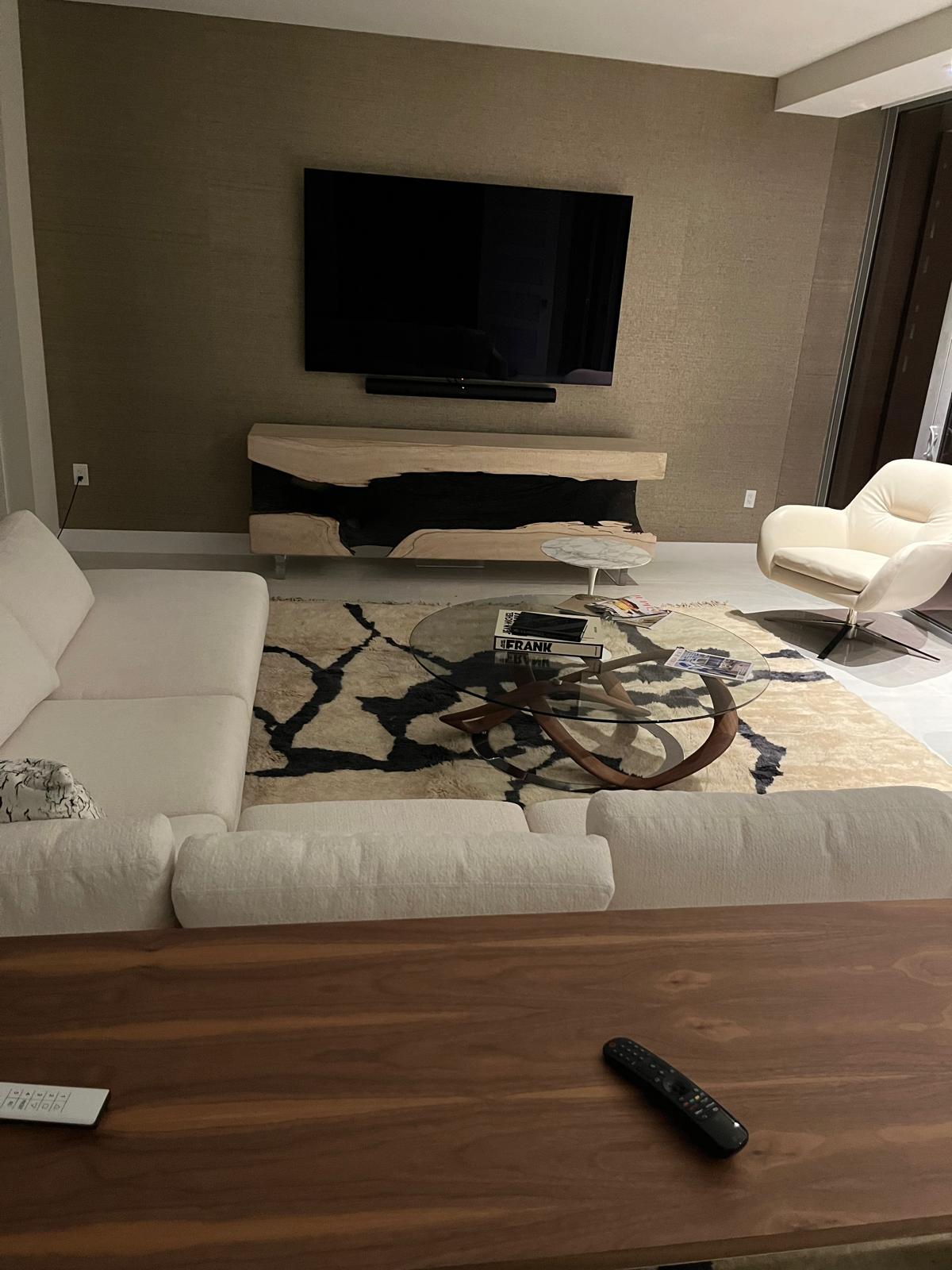 Lifestyle shot of the black and cream abstract Moroccan rug in a living room setting.
