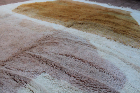Detail close-up of the texture of the brown and cream Moroccan rug.