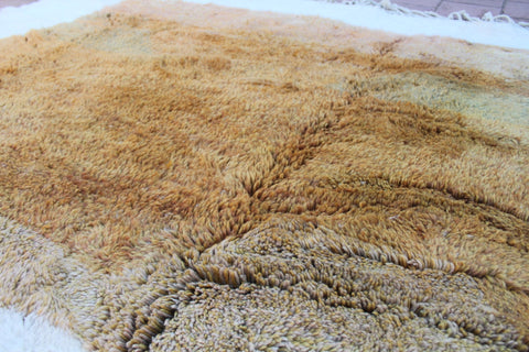 Detail close-up of the surface of the brown and cream Moroccan rug.