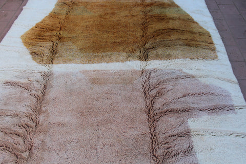 Detail close-up of the brown and cream Moroccan Mrirt rug with a striped design.