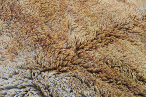 Detail close-up of the brown and beige Moroccan Mrirt rug showcasing its textured surface.