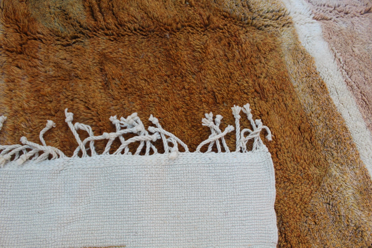 Detail close-up of the white and brown rug displaying an intricate design.