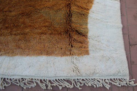 Detail close-up of the corner of the brown and cream Moroccan rug.