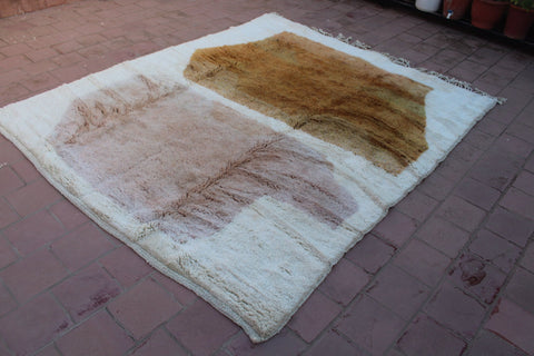 Detail close-up of the white and brown rug featuring a geometric pattern.