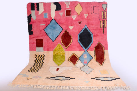 Front view of the pink Moroccan rug showcasing geometric designs against a studio backdrop.