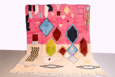 Front view of the pink Moroccan rug featuring geometric patterns on a studio background.