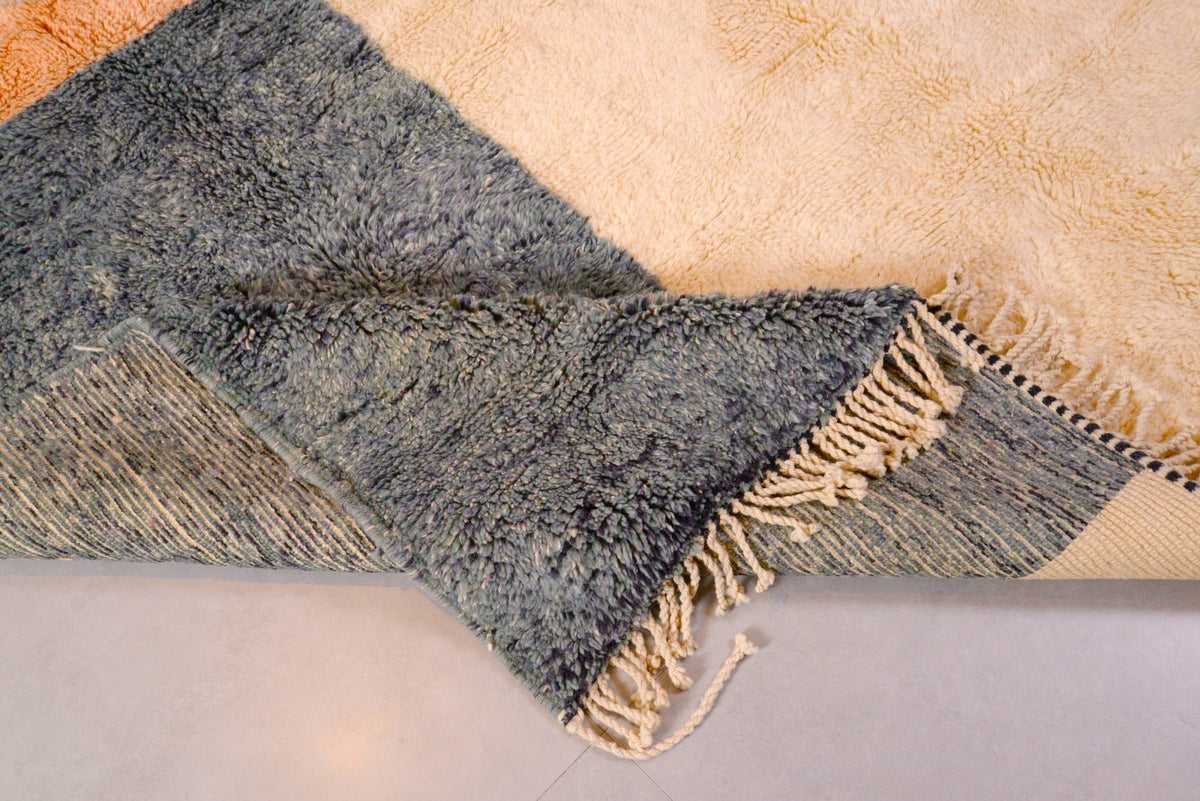 Detail view of the blue and beige geometric pattern on the Tizi N'Test Moroccan rug.
