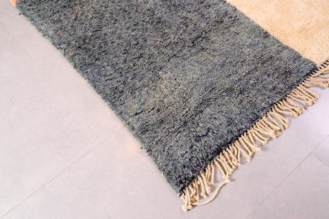 Detail close-up of the geometric patterns on the black and cream Tizi N'Test Moroccan rug.