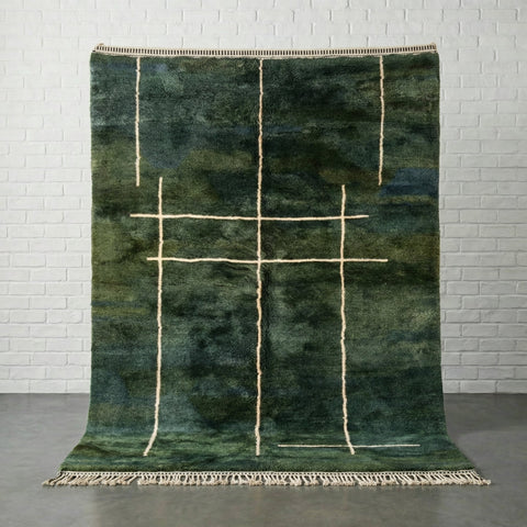 Front view of a green Moroccan rug featuring a geometric pattern and fringe edges.