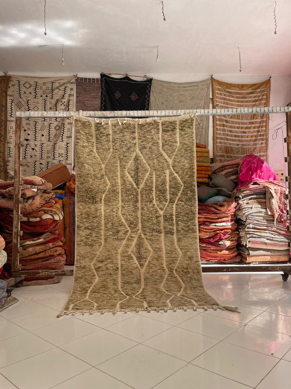 Lifestyle view of a vintage Moroccan rug showcasing beige and brown colors in a natural setting.
