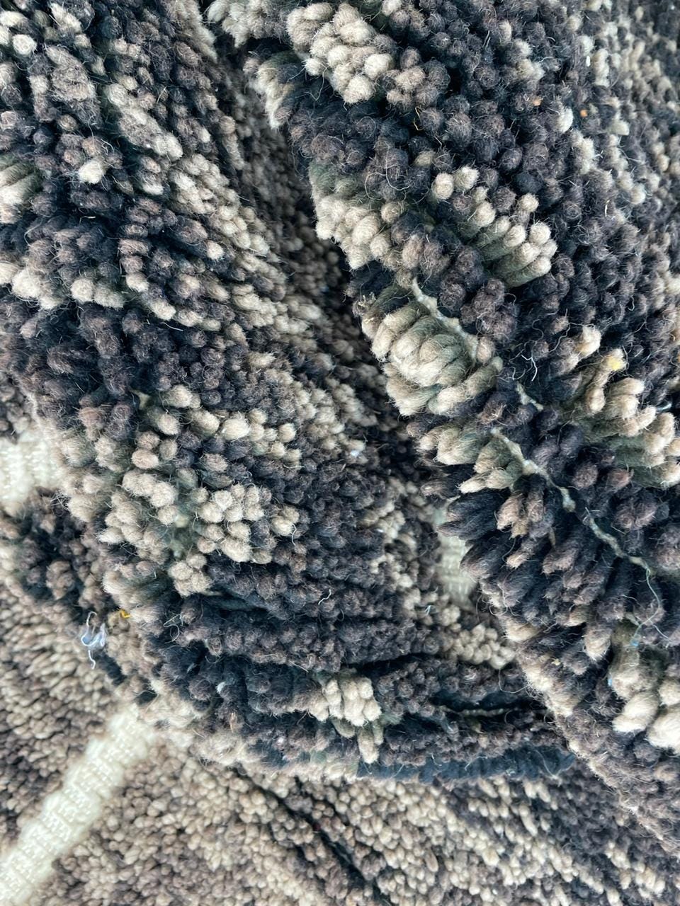 Detail close-up of a vintage Moroccan rug featuring black and white colors.